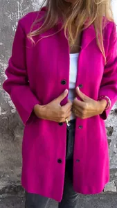 Detail of fuchsia single-breasted hooded jacket with textured fabric and black buttons.