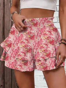 Close-up detail of women's pink floral print tiered wide-leg shorts with elastic high waist