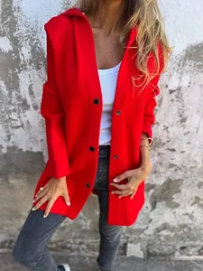 Detail of vibrant red hooded jacket with single-breasted button closure on a model.