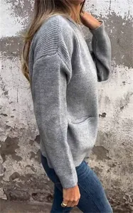 Detalle del bolsillo lateral y la textura acanalada de esta chaqueta de punto gris