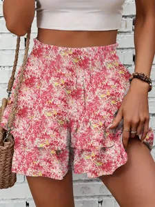 Detail of pink floral mini skort with ruffled layers and a high-waisted smocked band