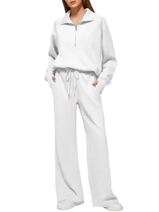 Full view of white two-piece tracksuit featuring half-zip sweatshirt and wide-leg pants