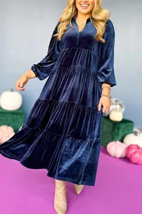 Detail of navy blue velvet V-neck tiered maxi dress with ruffled layers and long sleeves.