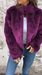 Close-up of a women's purple faux fur jacket with high collar and silver zipper.