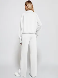 Back view of women's white two-piece loungewear set with zip-up top and wide-leg pants