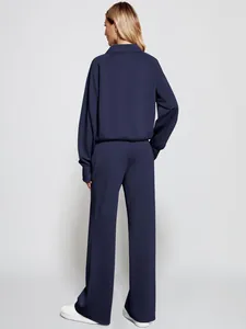 Full back view of women's navy blue two-piece casual tracksuit with wide-leg sweatpants