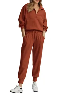 Full body view of women's rust ribbed loungewear set with half-zip top and matching joggers