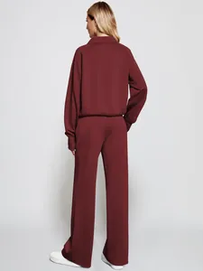 Back view of women's burgundy two-piece loungewear set with sweatshirt and joggers.