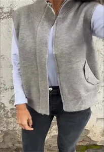 Close-up detail of a grey knitted zipper vest cardigan with high collar on model