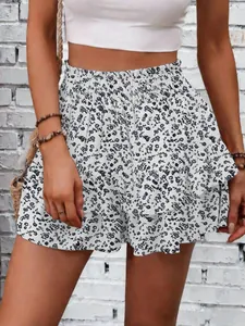Close-up of white floral wide-leg skirt-shorts with ruffle detail and elastic high waist