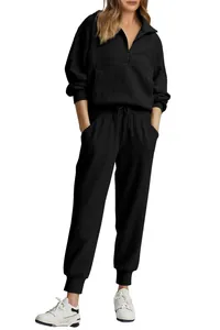 Detail view of women's black ribbed half-zip sweatshirt and matching sweatpants set