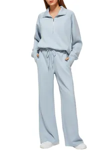 Detailed view of women's light blue two-piece lounge set with half-zip and wide-leg pants