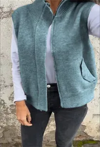 Detail of a casual women's zip-up knitted vest with a stand collar in a teal green finish