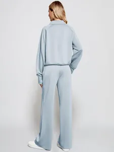 Back view of women's light blue loungewear set featuring sweatshirt and wide-leg pants