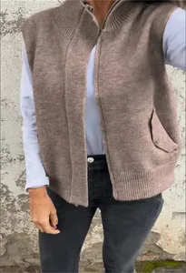 Close-up of brown knitted vest for women featuring stand collar and zipper closure detail.