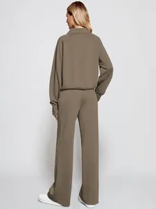 Back view of women's taupe two-piece sweatshirt and wide-leg sweatpants set