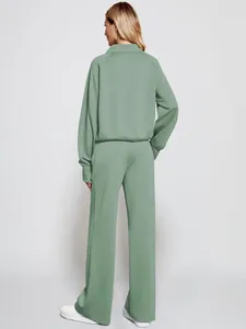 Rear view of stylish women's sage green zip-up sweatshirt and wide-leg joggers set