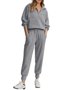 Women's grey ribbed two-piece casual set featuring a half-zip sweatshirt and jogger pants.