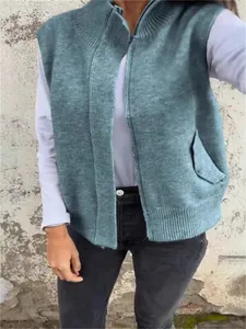 Loose fit dusty blue knit zip-up vest with stand collar and pocket for women.