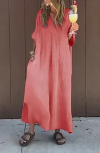 Detail view of a loose washed cotton V-neck maxi dress in coral orange