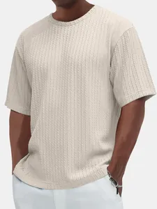 Detailed close-up of men's beige textured cable-knit round neck short sleeve t-shirt fabric.