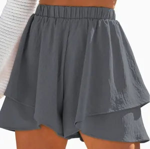 Close-up of gray elastic waist shorts with ruffled layered design and textured fabric