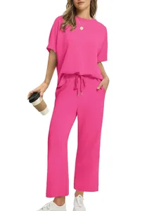 Vibrant pink two-piece summer set with loose short sleeve top and wide leg drawstring pants