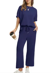 Women's casual navy blue two-piece set with short sleeve top and wide-leg pants.