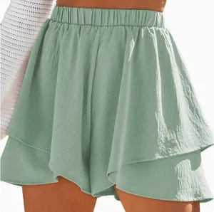 Close-up detail of green layered elastic waist culottes with soft linen-like texture