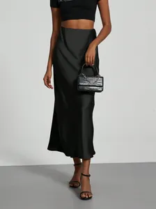 Elegant high-waisted black satin midi skirt with glossy finish for a sleek look