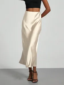 Detailed view of champagne satin midi skirt with high waist and elegant glossy finish