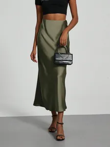 Close-up of elegant olive green high-waisted satin midi skirt featuring a silky glossy finish
