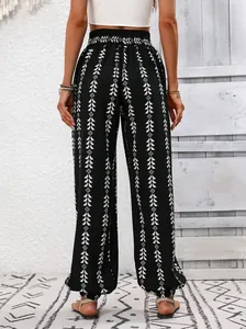 Back view showcasing the geometric pattern and elastic cuffs of black lantern pants