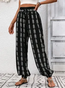 Detail of black and white geometric print harem pants with elastic waist and boho design