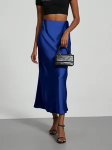 Close-up detail of royal blue satin midi skirt showing smooth fabric texture and high waist