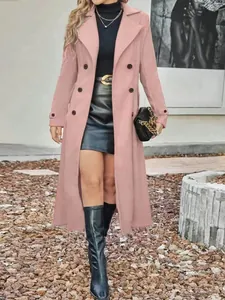 Elegant pink double-breasted long wool coat worn by model in outdoor setting