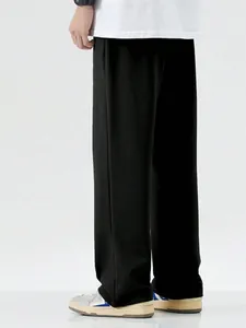 Rear view of men's loose black casual mopping trousers with a relaxed fit design