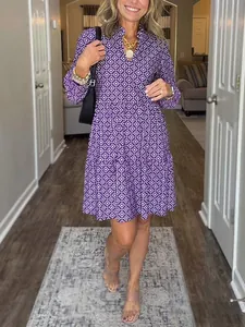 Detail showing the fit and purple geometric print of the stylish V-neck mini dress