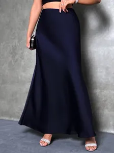 Detail of elegant navy blue high-waist satin maxi skirt with smooth texture
