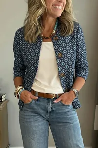 Gros plan d'une femme portant une veste courte bleue avec des motifs géométriques.