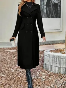 Model wearing a black long wool coat with double-breasted buttons in outdoor setting