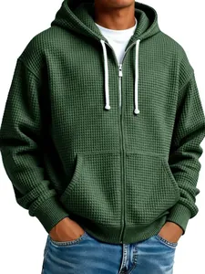 Detailed view of men's dark green waffle-knit hoodie with full zip and hood