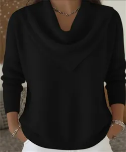 Detail of a black V-neck waffle knit sweater showing the neckline and fabric texture.