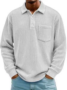 Detailed macro view of men's grey corduroy long sleeve polo shirt featuring chest pocket