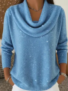 Detailed shot of a light blue long-sleeve top with sparkly silver silk and cowl neck.