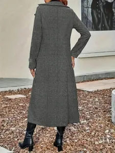 Detailed back view of a long grey textured wool blend coat for women in outdoor setting