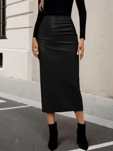 Detail view of a black high-waisted faux leather midi skirt with side ruching