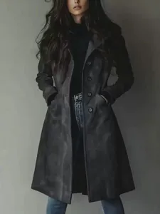 Women's elegant long dark suede trench coat featuring classic lapels and a buttoned front