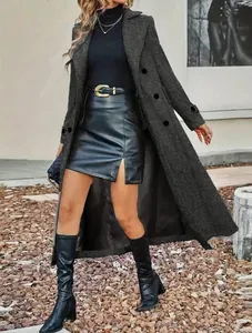 Detail view of a long dark grey woolen coat with lapel and double-breasted buttons
