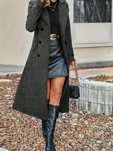 Full view of a stylish long grey double-breasted wool coat paired with a black leather skirt